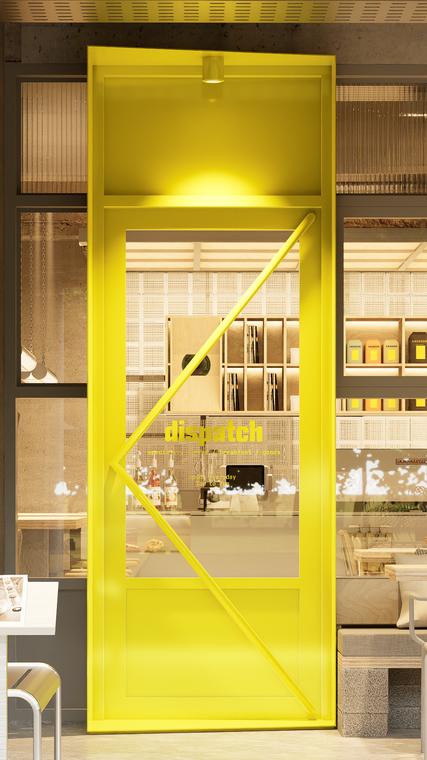 The acid yellow entrance door with the dispatch wordmark on the glass