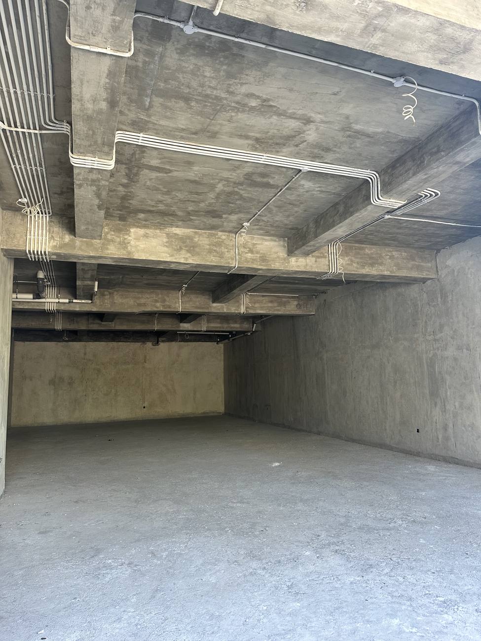 The raw concrete shell of the space during construction in July